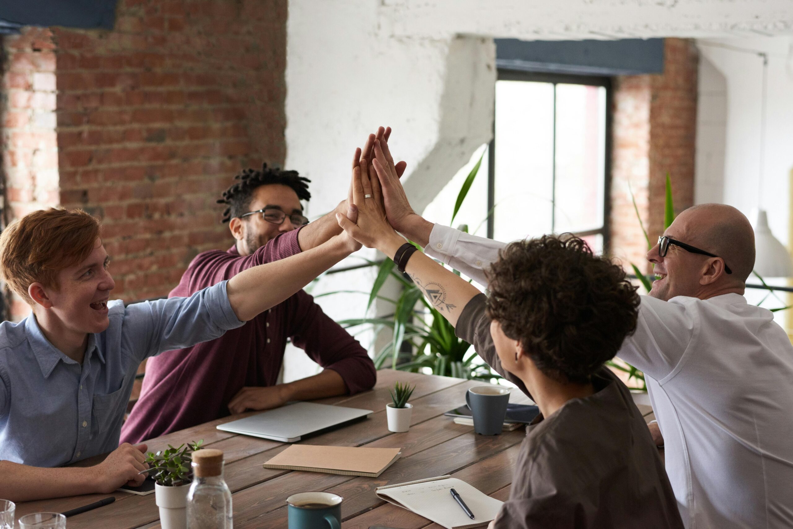 people high five for team success